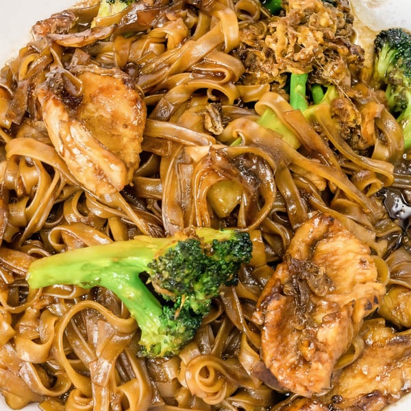 Close-up of Thai Village's Pad See Ew with wide noodles, chicken, and broccoli.